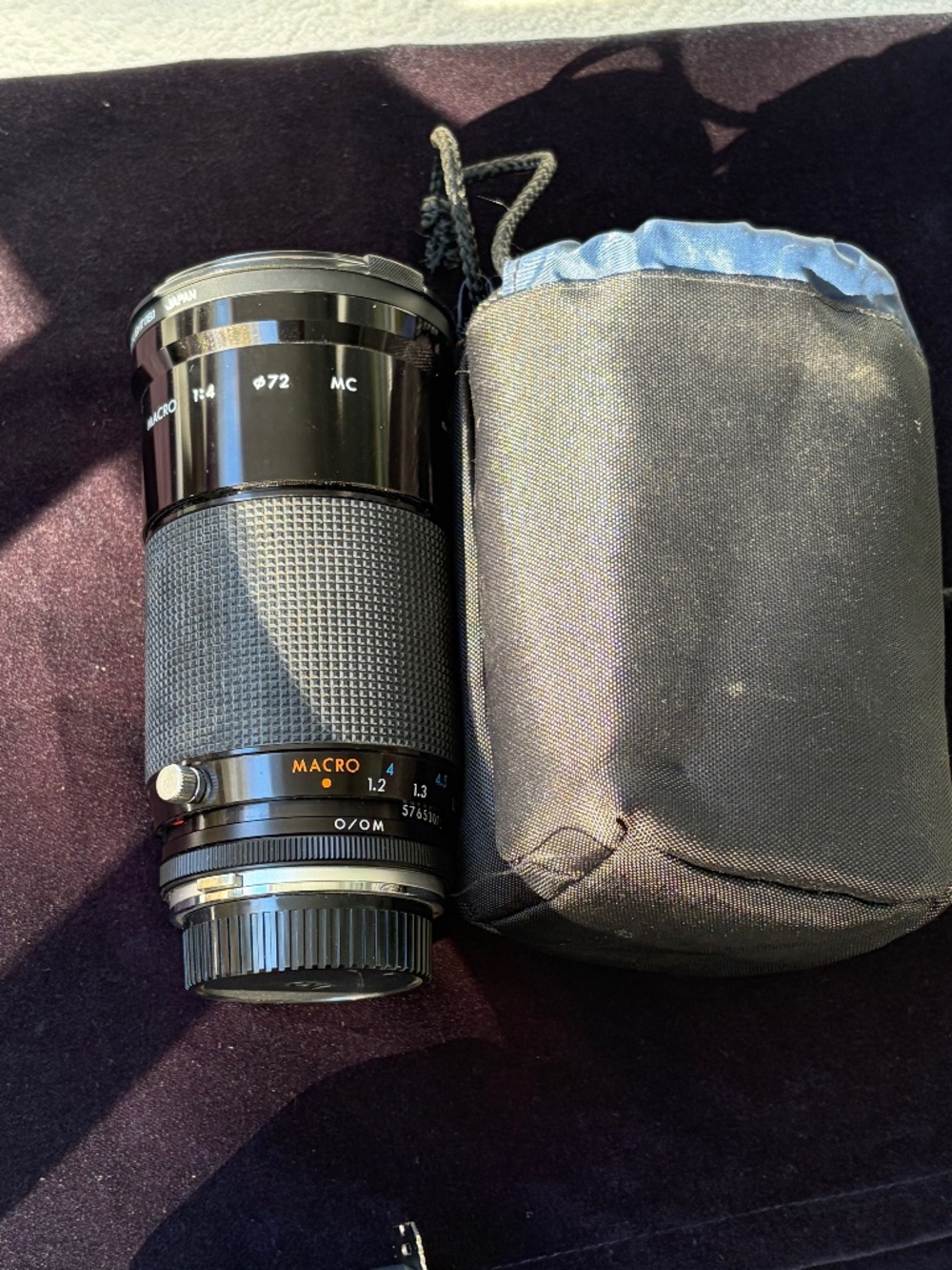 Camera lens, 28-210 mm (wide-angle to telephoto), made in Japan.